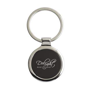 A round, polished, nickel metal keyring with black inlay and sturdy keyring. Each item is supplied in an individual brown cardboard envelope.