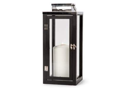 Black wooden lantern by Orrefors Jernverk. The lantern consists of painted pine wood with stainless steel details and glass walls. Opens and closes with a door at the front. The lantern is a stylish detail in any interior and also provides a cozy glow. In warm weather, the lantern can be used outside under a canopy (excl. candle).