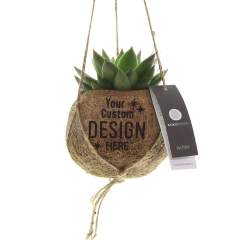 The Kokodama®, a botanical beauty that contains no plastic and is 99% natural and 100% biodegradable, offers a unique and sustainable option for corporate gifts. Its coconut fiber sphere creates a cozy and eco-friendly home for trendy and special plants. Hanging from the ceiling, placed on a table, or standing on the ground, the Kokodama® can find its natural habitat in any interior. Handcrafted in Sri Lanka, the Kokodama® contributes to the local economy and promotes craftsmanship. This Kokodama® mix contains various types of succulents, making it long-lasting and very easy to care for even for people without green thumbs.<br /><br />In addition to the Kokodama®'s distinctive appearance, this product provides an excellent opportunity for personalization with a logo or slogan. This makes it more than just a decorative object; it serves as a subtle means to promote your company or brand, or simply convey a message. In this way, you build a positive association with your company or brand as the Kokodama® graces the desks of associates or employees. The Kokodama® becomes even more delightful to give and receive thanks to the suitable gift packaging. By presenting this gift, you not only express appreciation, but also strengthen relationships and engagement, all while having a positive impact on your company's image.<br /><br />If you have any questions about this product, desired personalization, or packaging options, please feel free to contact us.