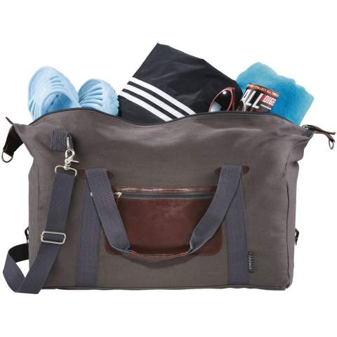 Exclusive design duffel, made of cotton canvas, features a large main compartment and unique Field & Co.™ details. Vinyl accents, front zippered pocket and durable handles. Sides can clip down when you are carrying less, or you can unclip the sides when the bag is fully stuffed. Also features trolley pass-through.
