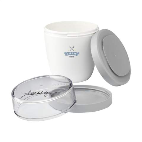 This plastic food jar made by Mepal is a handy product for transporting your lunch or snack. The food jar has two compartments. You can separate the two with a twisting motion. Both parts have a separate lid. The ideal solution for preventing spills while mixing. The volume of the upper transparent compartment is 200 ml, which means that it holds about 75 grams of muesli or fruit. The volume of the bottom compartment is 500 ml, enough for a generous portion of soup, noodles or yoghurt. A premium high-quality product. BPA-free, Food Approved and leak-proof. Microwave safe (except lid) and freezer safe. Comes with a 2-year Mepal manufacturer's warranty. Made in Holland.   STOCK AVAILABILITY: Up to 1000 pcs accessible within 10 working days plus standard lead-time. Subject to availability.