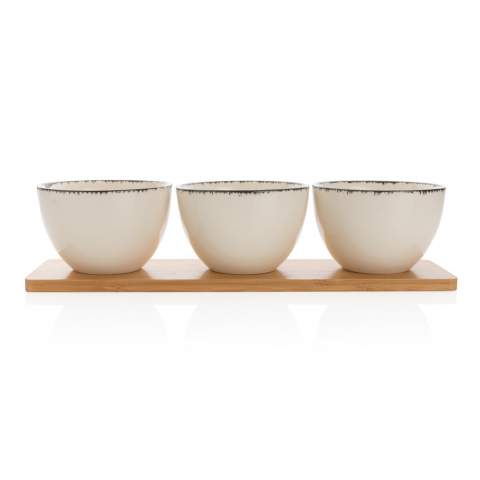 Make a big difference with small details in your home! With this Ukiyo 3pc serving bowl set you get 3 elegant and decorative ceramic bowls. The bowl has a beautiful and soft white colour with black edge that adds a rustic yet light and elegant touch. The bowl’s minimalist look is perfect for the modern home. The bowls come with a beautiful bamboo tray. Use to serve delicious snacks and treats. Dimensions: dia.: 13 cm, h.: 8 cm. Comes in kraft giftbox.