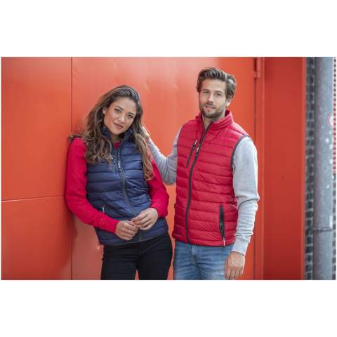 The Fairview women's lightweight down bodywarmer – perfect functionality to elevate your outdoor attire. This bodywarmer features elasticated binding on the bottom, offering a comfortable and slightly tight fit that adds protection against chilly winds. The outer shell fabric is made of nylon dull cire 20D woven with a water-repellent finish, ensuring exceptional durability and good protection against the elements. The lightweight material allows for easy movement and effortless wear throughout the day. The downproof pressed fabric prevents the down and feathers from escaping, ensuring long-lasting warmth and an extra level of durability. The down insulation is RDS certified (Responsible Down Standard), consisting of down and feathers, providing lightweight warmth without compromising ethical standards. A reliable companion for any outdoor adventure. This bodywarmer is designed with a fitted shape for a feminine look.
