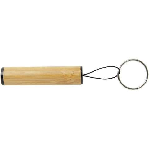 The Cane bamboo key ring with light is a compact and versatile accessory designed to provide you with convenient illumination whenever you need it. Just pull the polyester string to shine your light. The key ring can easily be attached keys, backpack, or any other personal belongings. The body is made of durable ABS material, ensuring long-lasting performance, and the outer case is crafted from bamboo, adding a touch of natural beauty to its design. Delivered with 3 LR41 batteries. Light capacity: 1.5V/30mAh. 