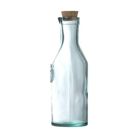 WoW! Decorative water bottle with spout. Made from 100% recycled, robust quality glass. Closes with a cork cap. An attractive bottle with character. The glass is embossed with the 'Authentic Glass 100% recycled' label.     The blue-green tint of this glass is a natural result of the recycling process. The colour and any imperfections emphasise the beauty of this recycled product and contributes to its authenticity. Recycling reduces the consumption of new raw materials, water and energy. Colour, thickness and size may vary by product. Made in Spain. Capacity 1,200 ml.