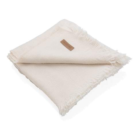 Give your home a stylish upgrade with this Ukiyo Aware™ Polylana® woven blanket. This high quality blanket is woven with fringed edges. Keep it on your sofa for cosy movie nights or on your bed for a beautiful layered look. With AWARE™ tracer that validates the genuine use of recycled materials. 2% of proceeds of each product sold containing AWARE™ will be donated to Water.org.