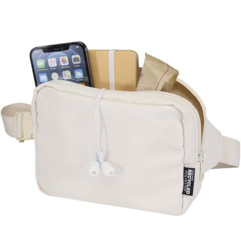 The Trip Aware™ recycled travel crossbody bag is a compact and functional bag designed for daily use and light travel. Made from durable 290D twill polyester with a knitted backing and lined with RPET 210D/PU, it features a clean, streamlined shape with practical storage options. The main zipped compartment holds your everyday essentials, while the back zipped pocket includes a ribbon for keys, as well as dedicated slots for pens and a passport. The adjustable strap with buckle ensures a secure and comfortable fit during movement. Each bag also comes with an Aware™ tracer. This innovative feature allows users to trace the origins and journey of their item through a QR code, enhancing transparency in the supply chain and fostering a stronger connection between the product and its production process. Volume capacity: 1 litre.