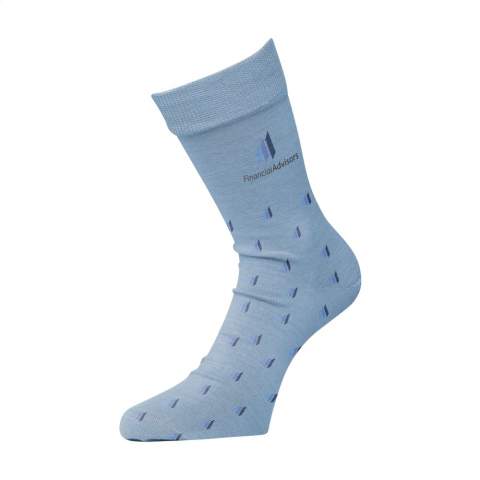 Socks made from knitted cotton (80%), polyamide (15%) and lycra (5%). Including knitted, customised design. Choose a subtle pattern or a distinct design over the whole sock. The socks can be knitted in up to 7 different colours. Choose from multiple colours of yarn. The socks are attached to each other with a cardboard label. This can also be given your own full-colour design. This allows you to design your own socks, fitting your house style and requirements perfectly. Available in sizes XS (35-37), S (38-40), L (41-43) and XL (44-46). Wash at a maximum temperature of 30 degrees. Do not tumble dry. Do not iron. Minimum order: 50 pairs of socks per size.
