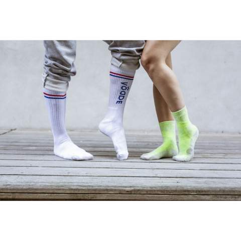 Comfortable socks from Vodde made using a 100% circular economy manufacturing process. These socks are made from collected textiles. The socks consist of 53% recycled cotton (from collected pieces of fabric), 38% recycled polyester (from collected PET bottles), 6% nylon and 3% elastane. Including knitted-in, customised design. All Vodde socks are supplied as standard in pairs with a label, which can be printed in your own full colour design. This way you can design your own socks that perfectly match any corporate identity. These thin quality socks, designed for everyday use, are perfect to combine with a casual outfit.   • Available in sizes M (36-40) and L (41-46). • Minimum order: 100 pairs of socks per size. Minimum order in total: 200 pairs of socks.  • Optional: Supplied in pairs in a (customised) box made from recycled  cardboard - possible from 1,200 pairs of socks.   • By wearing these socks you are contributing to a sustainable world with less pollution. Developed and tested in the Netherlands. Made in the EU.   • The base of the socks is made of recycled yarn and comes in a standard colour. You can choose from 21 standard colours of recycled yarn. Any pattern in the base, cuff, heel and toe can be realised in any colour of your choice.   • The Dutch company Vodde reuses discarded textiles to make new products designed by Dutch designers. Vodde makes its yarn from cotton collected by local 'rag farmers' and from cutting waste from textile production in European countries where Vodde makes its own products. In addition, polyesters derived from PET bottles, nylon, fishing nets and other collected waste are also used.
