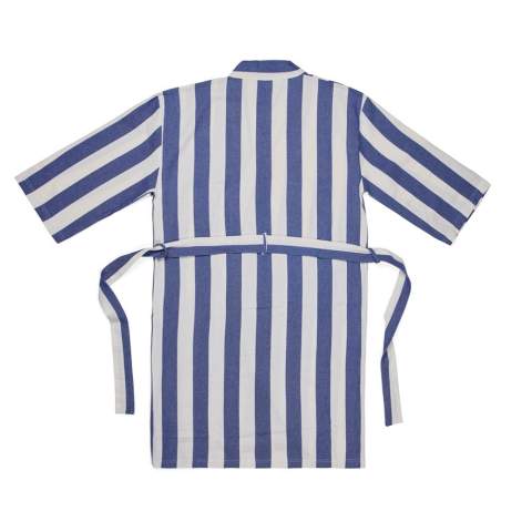 Bring this soft and comfortable hammam robe to the beach or simply enjoy it at home. Crafted from a lightweight and airy 200 gsm blend, it combines the comfort of cotton with the quick-drying benefits of polyester. Designed in a classic style with a two-tone striped pattern, it features a neat collar, front pockets, 3/4 sleeves, and a waist belt for a perfect fit. Certified by GRS (Global Recycled Standard), GRS certification guarantees that the entire supply chain of the recycled materials is certified. The total recycled content is based on the overall product weight. This product contains 69% GRS certified recycled cotton and 29% GRS certified recycled polyester.
