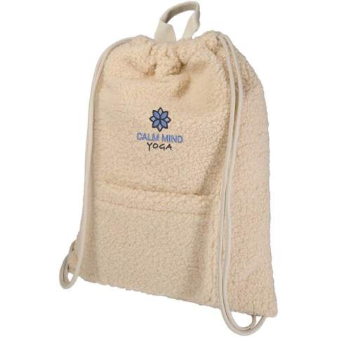 The Bear sherpa drawstring backpack is made from GRS certified recycled polyester. It features a spacious main compartment, a convenient front pocket for quick-access items, and a top handle for easy carrying. Volume capacity: 9 litres.