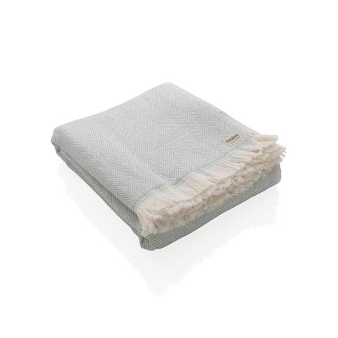 Our most luxurious and versatile towel. The perfect travel companion in any circumstance.  This towel contains 22% recycled cotton and is super soft and silky to the touch. With AWARE™ tracer that validates the genuine use of recycled cotton. You can use it for almost anything, such as the beach, travelling, sauna, swimming pool, camping, sports, as a beach towel, bath towel, scarf, pareo, yoga towel, blanket, as a wrap for your child - you name it. Perfect for sofas and dressing beds, the Hisako throws are also wonderful for sunbathing on or using as a machine-washable picnic blanket. These four seasons hammam towels are quick-drying, mould resistant and incredibly easy to clean making them a brilliant choice for allergy sufferers, red wine lovers and beachgoers. 2% of proceeds of each Impact product sold will be donated to Water.org. Machine washable. Made in Portugal.