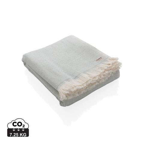 Our most luxurious and versatile towel. The perfect travel companion in any circumstance.  This towel contains 22% recycled cotton and is super soft and silky to the touch. With AWARE™ tracer that validates the genuine use of recycled cotton. You can use it for almost anything, such as the beach, travelling, sauna, swimming pool, camping, sports, as a beach towel, bath towel, scarf, pareo, yoga towel, blanket, as a wrap for your child - you name it. Perfect for sofas and dressing beds, the Hisako throws are also wonderful for sunbathing on or using as a machine-washable picnic blanket. These four seasons hammam towels are quick-drying, mould resistant and incredibly easy to clean making them a brilliant choice for allergy sufferers, red wine lovers and beachgoers. 2% of proceeds of each Impact product sold will be donated to Water.org. Machine washable. Made in Portugal.