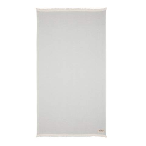 Our most luxurious and versatile towel. The perfect travel companion in any circumstance.  This towel contains 22% recycled cotton and is super soft and silky to the touch. With AWARE™ tracer that validates the genuine use of recycled cotton. You can use it for almost anything, such as the beach, travelling, sauna, swimming pool, camping, sports, as a beach towel, bath towel, scarf, pareo, yoga towel, blanket, as a wrap for your child - you name it. Perfect for sofas and dressing beds, the Hisako throws are also wonderful for sunbathing on or using as a machine-washable picnic blanket. These four seasons hammam towels are quick-drying, mould resistant and incredibly easy to clean making them a brilliant choice for allergy sufferers, red wine lovers and beachgoers. 2% of proceeds of each Impact product sold will be donated to Water.org. Machine washable. Made in Portugal.