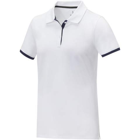 The Morgan short sleeve women's duotone polo is a stylish and comfortable option for any casual or business setting. Made from a 200 g/m² piqué knit cotton fabric, this polo is both durable and breathable. Featuring a flat knit collar and rib cuffs with contrast colour detailing, this polo offers a modern twist on a classic design. The two-button placket and pick-stitch details add an extra touch of sophistication, and the satin neck tape and heat transfer main label provide comfort and ease of wear. This polo is designed with a fitted shape for a feminine look.