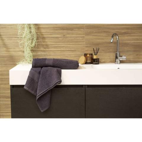 Cette serviette de bain de la marque Wooosh est composée à 50% de coton recyclé et à 50% de coton. La serviette a une boucle pratique et une bande tissée et elle est magnifiquement finie avec une bordure en coton. La douceur de l'éponge au tissage serré donne une sensation de luxe et de confort après une douche revigorante ou un bain chaud. Les fibres des 400 grammes de coton éponge absorbent très bien l'humidité et sont agréables sur la peau pendant le séchage. Ce textile de salle de bain a un look intemporel et s'intègre dans tous les intérieurs. Ce produit est certifié GRS et fabriqué avec une attention particulière portée aux personnes et à l'environnement.