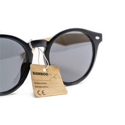 Sunglasses with a stylish, round, matt black frame, bamboo temples, and black lenses with UV 400 protection (according to European standards).