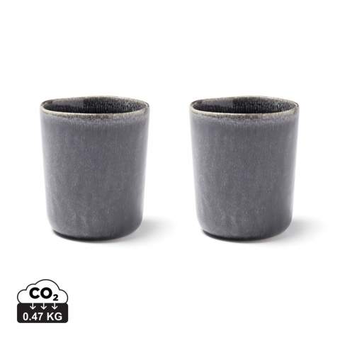 Set of two stoneware mugs. Use for tea or coffee. Nomimono draws its inspiration from nature and the earth around us, creating this rustic range in natural earth tones where no two items are the same. Japanese meets Scandinavian, rustic meets modern. Collectibles for a down-to-earth and inspiring serving. Each item is handmade and glazed three times in order to obtain the right kind of finish. It makes each item completely unique. Dishwasher and microwave safe.