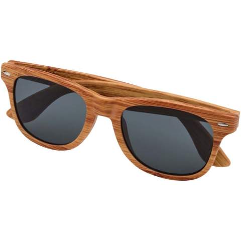 Sunglasses with a retro design and a wooden look finish. These sunglasses with UV 400 lenses are rated as Category 3 making them the perfect choice for protection against bright sunlight. Compliant with EU safety standard EN12312-1. The PC plastic allows the product to be slightly bendable for comfort.