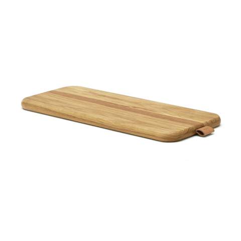 Exclusive oak serving board with a fine faux leather detail. Excellent for serving and, when not in use, the cutting board is a nice detail on the kitchen counter.