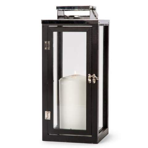 Black wooden lantern by Orrefors Jernverk. The lantern consists of painted pine wood with stainless steel details and glass walls. Opens and closes with a door at the front. The lantern is a stylish detail in any interior and also provides a cozy glow. In warm weather, the lantern can be used outside under a canopy (excl. candle).