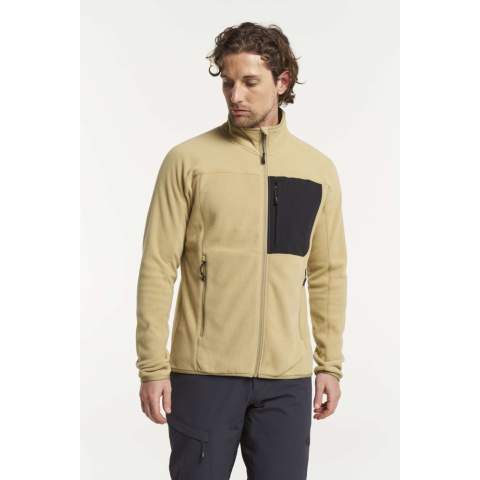 Onze Himalaya Full Zip Pocket Fleece is gemaakt van Tensons lichtgewicht 100% gerecycled polyester, dat duurzaamheid en veelzijdigheid combineert. Deze zachte, behaaglijke stof is zeer ademend en droogt snel, waardoor hij ondanks het minimale gewicht warmte en comfort biedt. Draag hem als isolerende tussenlaag of op zichzelf op een koele herfstdag. Met één borstzak met ritssluiting, twee zijzakken met ritssluiting, elastische manchetten en taille, een zachte kraag en een ritssluiting over de volledige lengte, ben je klaar voor elk avontuur!
