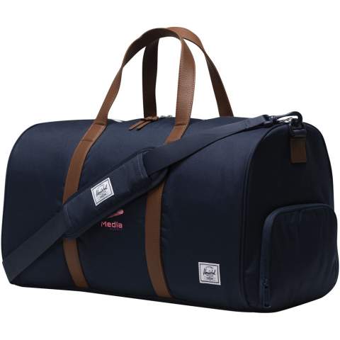 Looking for the ultimate road trip duffel – the Herschel Novel™ duffle bag is yours. This duffel is engineered for rugged durability and intelligent organization, featuring the signature shoe compartment to accommodate that essential extra pair. Expertly crafted from 100% recycled EcoSystem™ fabrics, it fits snugly in overhead bins or trunks, making it the perfect travel companion. The 600D fabric is thoughtfully fashioned from 100% recycled post-consumer water bottles, while the waterproof zippered closure ensures the protection of your precious essentials. This duffle bag is designed with vegan leather handles and a removable smooth webbing shoulder strap, complete with EVA padding, for comfortable carrying. The Herschel Novel™ duffle bag also features an outside sleeve pocket allowing you to easily organize and access your belongings. With a voluminous capacity of 43L, this duffel is the ultimate travel partner for your next adventure.
