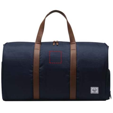 Looking for the ultimate road trip duffel – the Herschel Novel™ duffle bag is yours. This duffel is engineered for rugged durability and intelligent organization, featuring the signature shoe compartment to accommodate that essential extra pair. Expertly crafted from 100% recycled EcoSystem™ fabrics, it fits snugly in overhead bins or trunks, making it the perfect travel companion. The 600D fabric is thoughtfully fashioned from 100% recycled post-consumer water bottles, while the waterproof zippered closure ensures the protection of your precious essentials. This duffle bag is designed with vegan leather handles and a removable smooth webbing shoulder strap, complete with EVA padding, for comfortable carrying. The Herschel Novel™ duffle bag also features an outside sleeve pocket allowing you to easily organize and access your belongings. With a voluminous capacity of 43L, this duffel is the ultimate travel partner for your next adventure.
