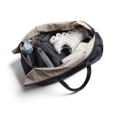 A traditional duffel with a twist, this bag is rugged enough for adventure, but light enough to let you move like the wind. Durable ripstop is 3x lighter than our other fabrics. Can be folded or rolled, and packed for travel. Zipper opens from each end, for ultra-wide, unobstructed access. External zip compartment with slip pockets and integrated key clip. Internal cap pockets at each end. Reinforced rim provides stability when zipping. Adjustable and detachable padded shoulder strap.