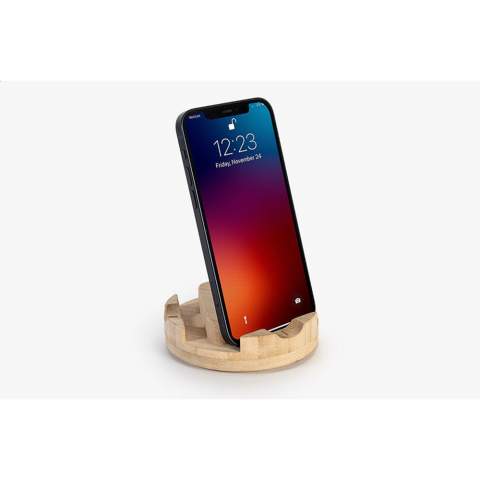 This spinning phone stand is made from bamboo.  A handy phone stand for video calls, video watching, or just to always have your phone ready to unlock with Face ID.  The spinning dock has three slots in different widths to make sure all phones, and most phone covers will fit. Whether you want to have your phone more upright during a video call. Or more laidback when binging your favorite show. This product is made from bamboo. Bamboo is a fast growing plant with timber specs. It grows to maturity in 5 years versus 30 – 120 years for timbers. After a bamboo plant is harvested, four to seven new plants will grow from its roots. No replanting necessary, just like that, made possible by nature.  Bamboo is known for its hard surface, making it a robust and long lasting material. Despite its hardness it is very suitable to craft. That’s why our Docks are so nicely rounded. Each item is supplied in an individual brown cardboard box.