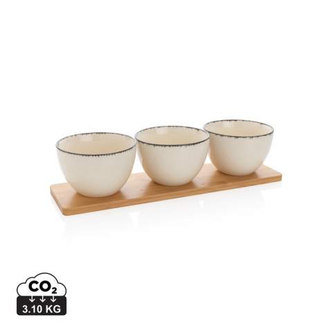 Make a big difference with small details in your home! With this Ukiyo 3pc serving bowl set you get 3 elegant and decorative ceramic bowls. The bowl has a beautiful and soft white colour with black edge that adds a rustic yet light and elegant touch. The bowl’s minimalist look is perfect for the modern home. The bowls come with a beautiful bamboo tray. Use to serve delicious snacks and treats. Dimensions: dia.: 13 cm, h.: 8 cm. Comes in kraft giftbox.