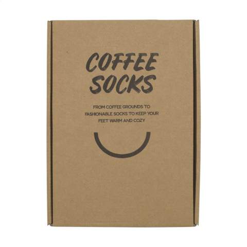 WoW! Socks made from coffee grounds. Coffee grounds remain after brewing and are then used to create this product. This includes making yarn. These socks are knitted from these yarns. The composition of these socks is 59% coffee yarn, 35% recycled polyester and 6% recycled elastane. One-size (41-46). Worldwide, we produce around 50 billion kilograms of coffee grounds each year. What’s left over just gets thrown away… But not anymore! Coffee grounds are mixed with recycled PET to create coffee yarn. This yarn can then be used to be woven into products like these socks. These socks are not only beautiful because of the design that is based on the color of a freshly made cup of coffee. They also help to reuse our worldwide production of coffee waste. Each item is supplied in an individual brown cardboard box.