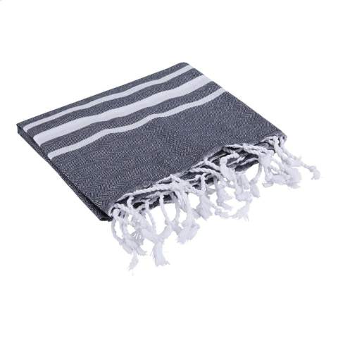A multifunctional hammam towel from Oxious. Made from 50% OEKO-TEX® certified cotton and 50% recycled industrial textile waste (140 g/m²). Vibe is a wonderfully soft and stylish cloth with a cool stripe pattern. Beautiful as a shawl, dress on the couch, luxurious (hammam) cloth or towel. The cloth is handmade. Vibe symbolizes relaxation in a cozy atmosphere and environment.      These beautiful, soft cloths are made by local women in a small village in Turkey. They work there in a social context, with room for growth and development. The cloths are handmade with love and care for the environment. Pure enjoyment can begin with a product from the Oxious collection. Optional: Each item supplied in a kraft cardboard envelope and/or with a kraft sleeve.