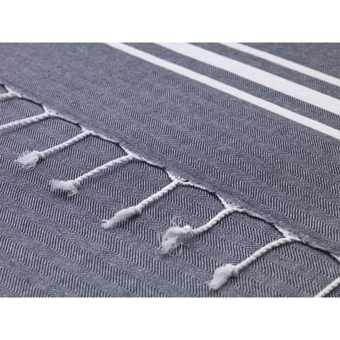 A multifunctional hammam towel from Oxious. Made from 50% OEKO-TEX® certified cotton and 50% recycled industrial textile waste (140 g/m²). Vibe is a wonderfully soft and stylish cloth with a cool stripe pattern. Beautiful as a shawl, dress on the couch, luxurious (hammam) cloth or towel. The cloth is handmade. Vibe symbolizes relaxation in a cozy atmosphere and environment.      These beautiful, soft cloths are made by local women in a small village in Turkey. They work there in a social context, with room for growth and development. The cloths are handmade with love and care for the environment. Pure enjoyment can begin with a product from the Oxious collection. Optional: Each item supplied in a kraft cardboard envelope and/or with a kraft sleeve.
